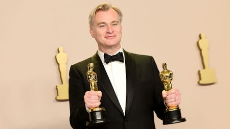 Christopher Nolan with his Oscars for Oppenheimer