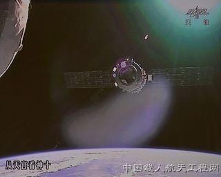 An exterior camera on China's Tiangong 1 module captures the approach of the Shenzhou 10 spacecraft as it nears the space laboratory during a 15-day spaceflight , China's longest yet, in June 2013.