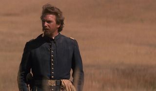 Dances with Wolves Kevin Costner stands in the wheat field, in uniform