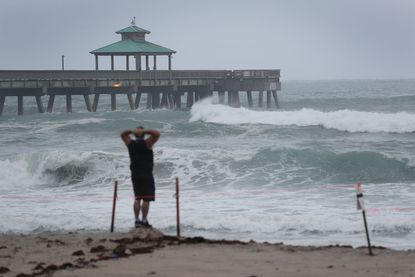 A man stands on the beach in Deerfield Beach, Florida.