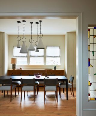 dining room with stained glass window panel and cream walls