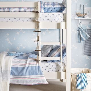 bedroom with blue designed wall white floor and white bunk bed