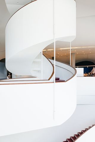 White and wood curved staircase inside the National Taichung Theater