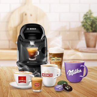Image of Tassimo by Bosch Style coffee machine next to different brewed hot drinks