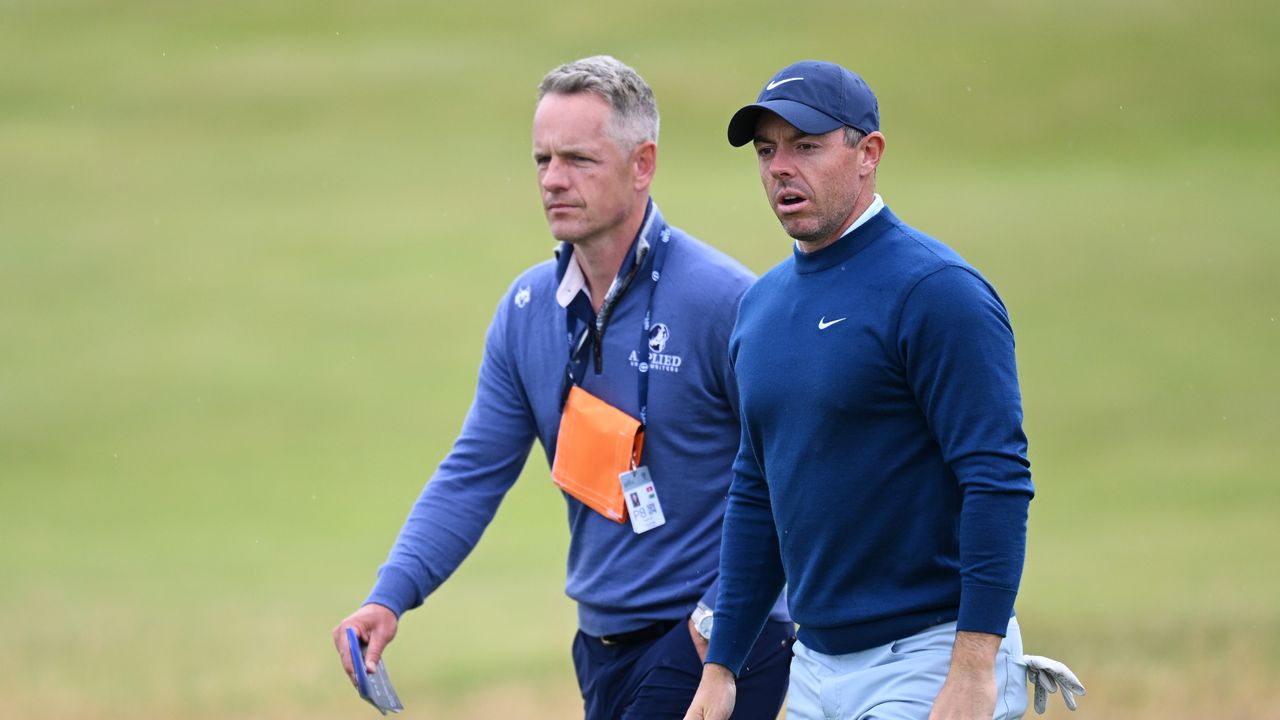 Luke Donald of England and Rory McIlroy of Northern Ireland walk on course during a practice round prior to The 152nd Open championship at Royal Troon on July 16, 2024 in Troon, Scotland.