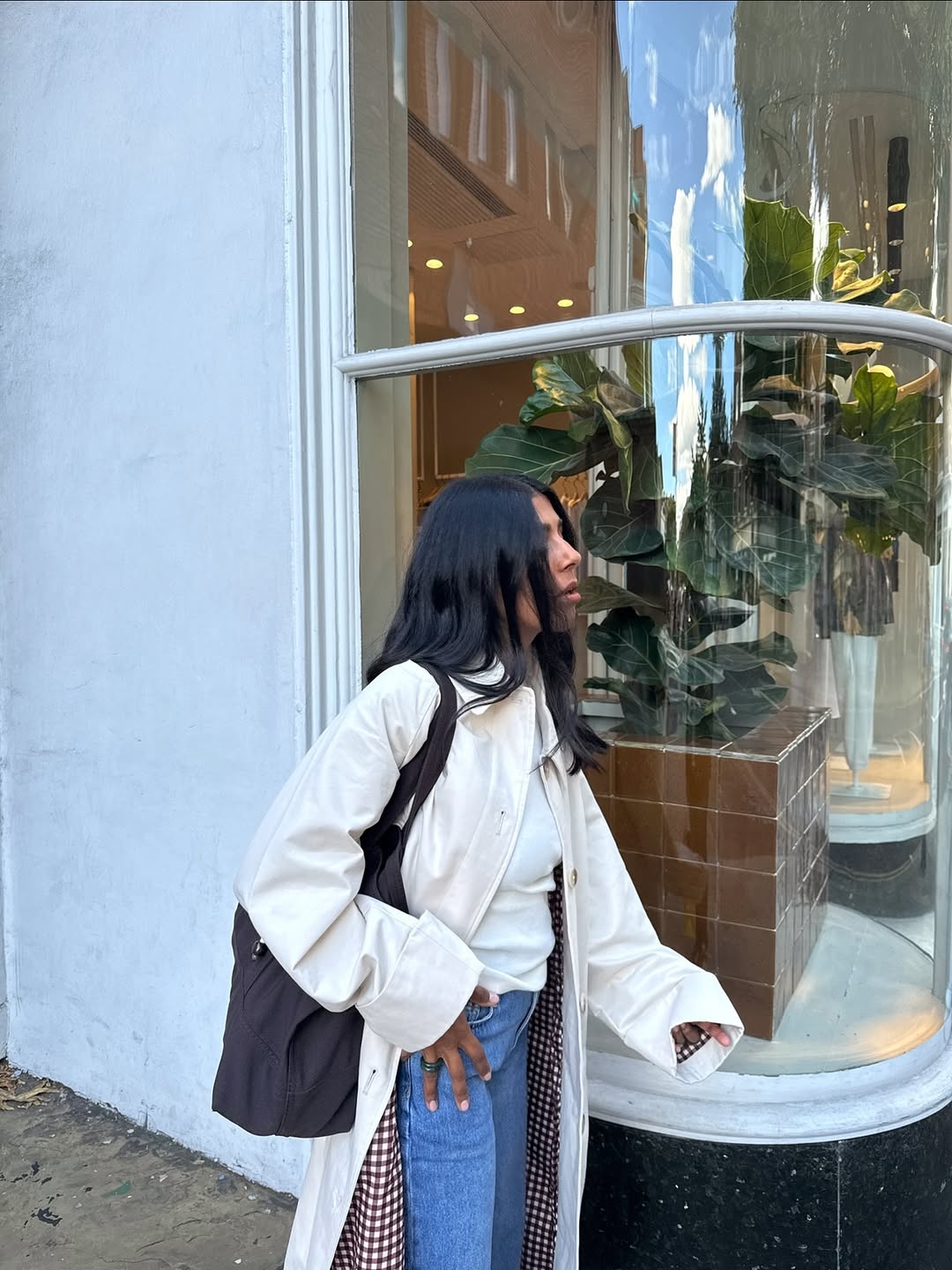 Monikh wearing a cream Nobody&#039;s Child trench coat