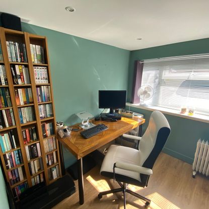 Home office in a converted garage with large window bringing in light