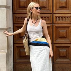 @chloekathbutler wears a white tank, white skirt and printed silk scarf