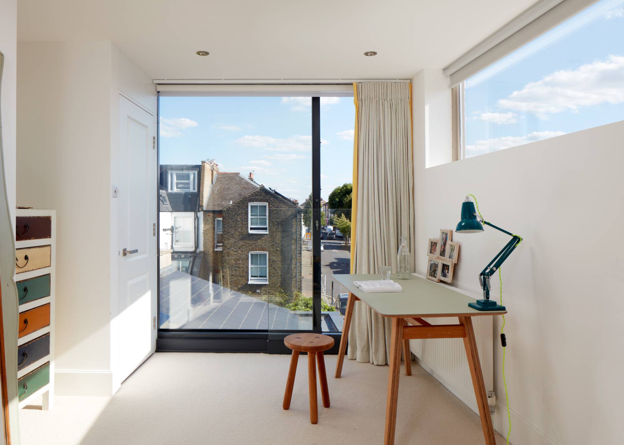 white hobby room/office with floor to ceiling window and view to terrace house