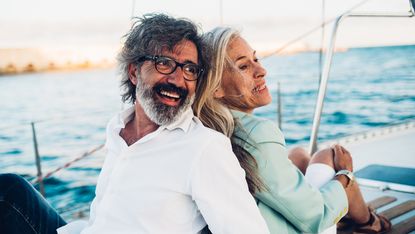 Senior couple enjoying cruising on their yacht.