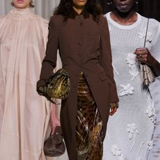 snakeskin purses shown in a collage of close photos of models walking down the runway shows of Ferragamo, Jil Sander and Dries Van Noten carrying python handbags