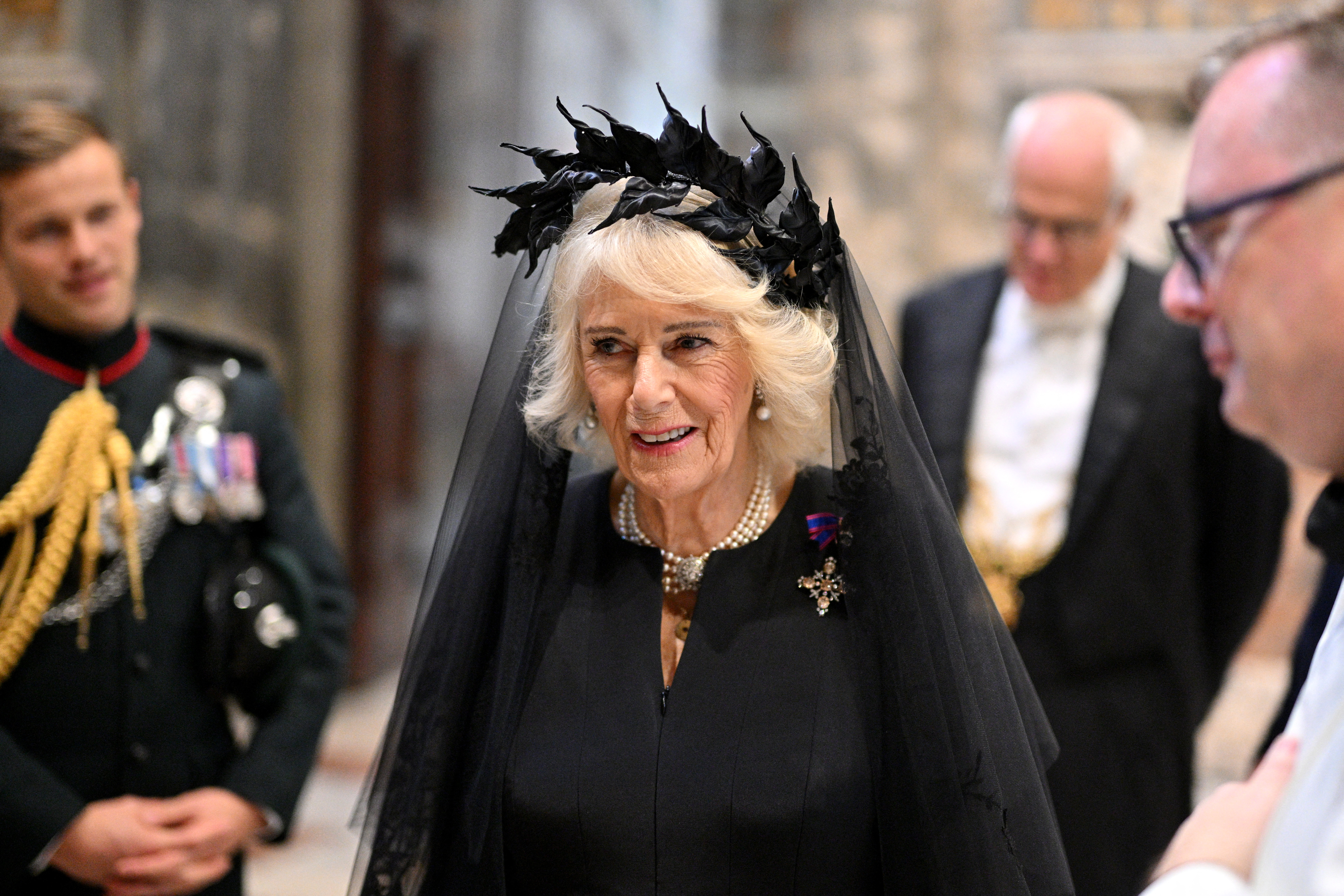 Queen Camilla wearing a black veil and dress at the Vatican