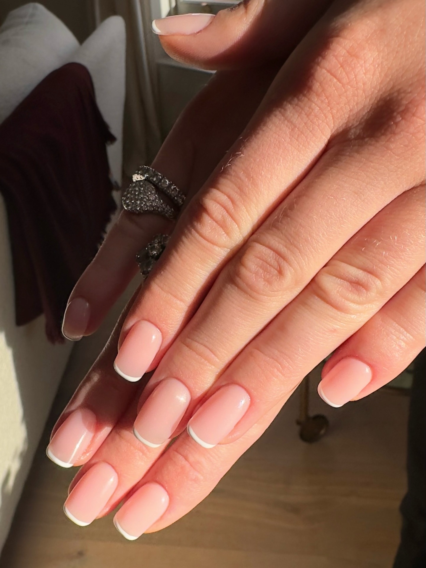 French-tipped squoval nails.