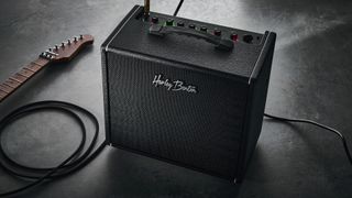Harley Benton DNAFX AmP20: the compact 1/8" modelling combo is finished in black and photographed in close-up and against a slate floor
