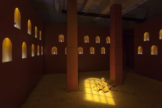 image of room with warm lighting and clay sculptures all around