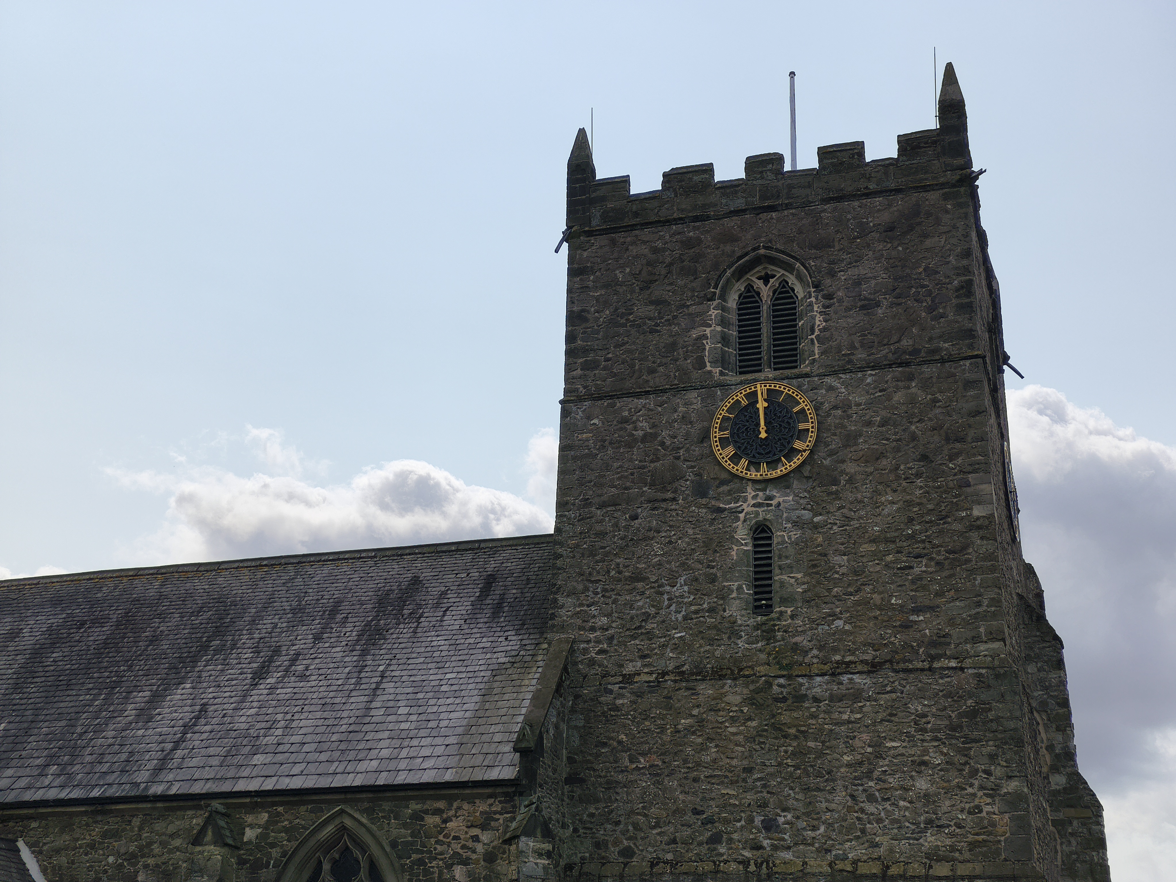 Church clocktower in front of a blue sky