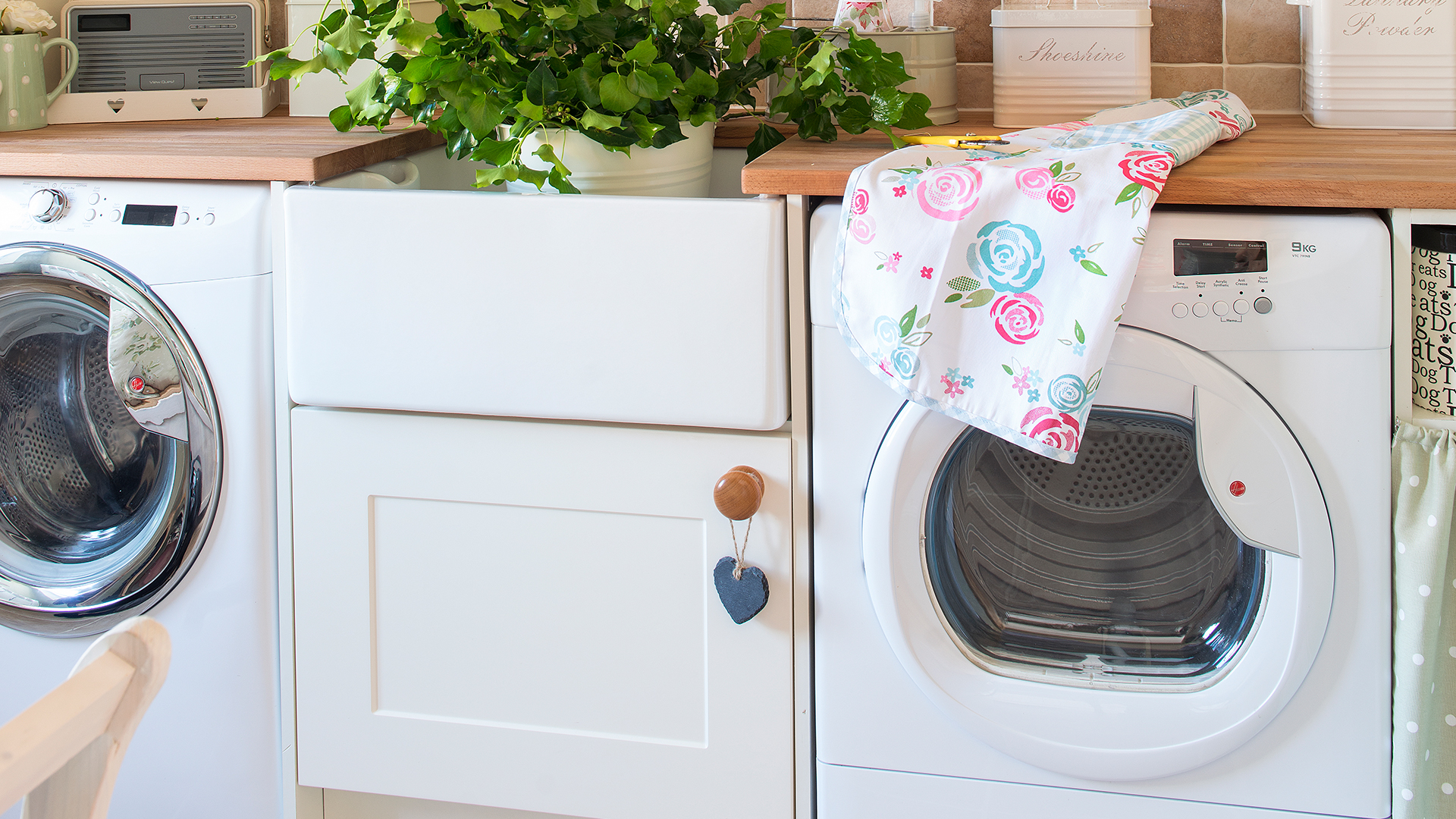 washer dryer either side of a butler sink in a kitchen