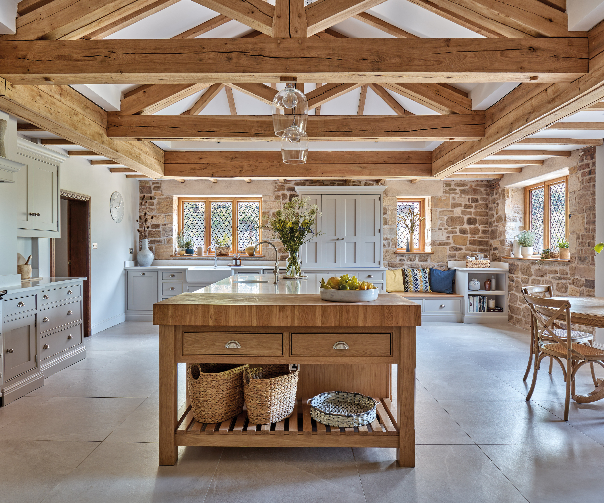 large wooden vaulted ceiling with long island and butcher block style table attached