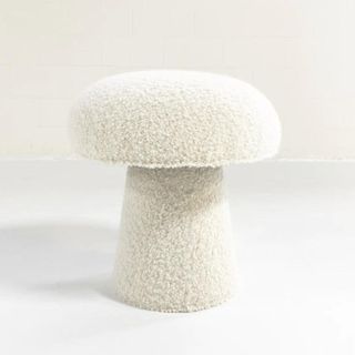 A white mushroom pouf in white boucle