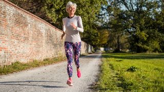 Older woman running outside as part of her menopause exercise plan