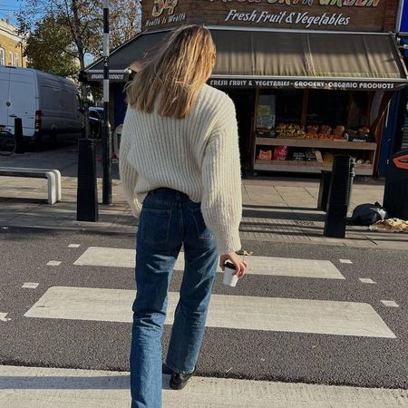 Lizzy Hadfield in beige jumper and jeans and loafers