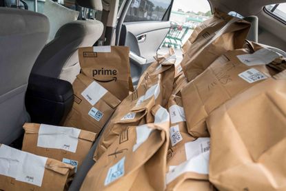 Amazon Prime grocery bags sit inside a car outside a Whole Foods Market in Berkeley, California