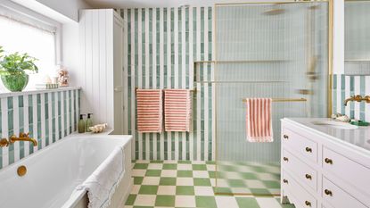 Green stripe tile bathroom with reeded shower door