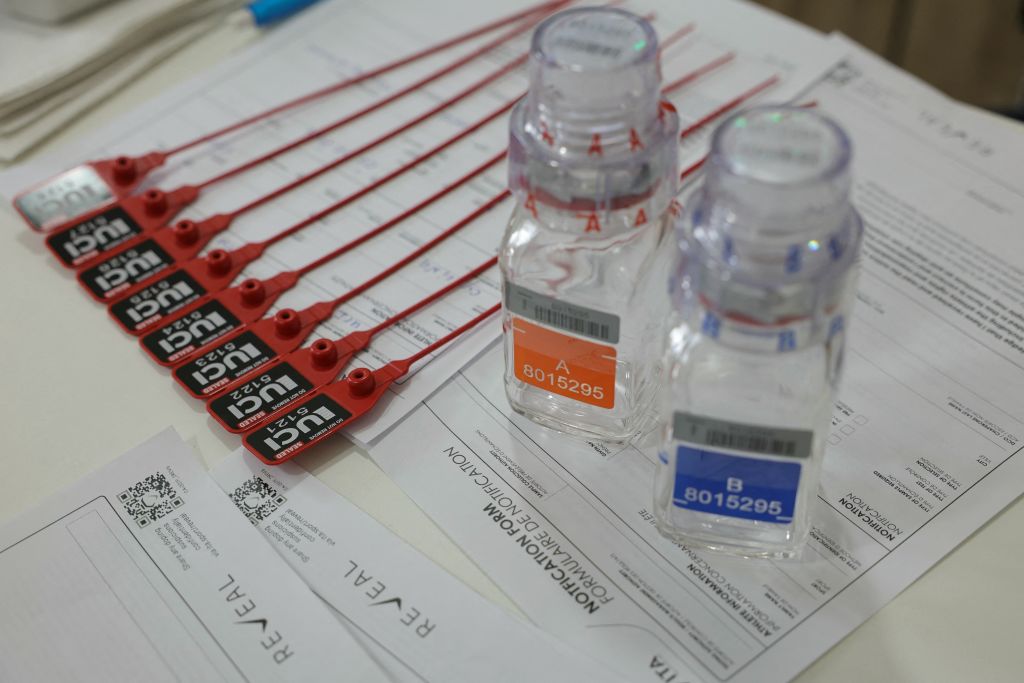 This photograph taken on July 5, 2024, shows anti-doping testing kit materials displayed at the International Testing Agency (ITA) testing facility inside a truck at the finish line of the 7th stage of the 111th edition of the Tour de France cycling race, 25,3 km individual time trial between Nuits-Saint-Georges and Gevrey-Chambertin. The overall leader yellow jersey rider and stage winner are systematically summoned to be tested for doping after the day's stage, along with any rider selected by ITA based on performance or intelligence from the organisation's investigative department. A chaperon escorts the rider to the facility where a supervised urine sample is collected for testing. (Photo by Thomas SAMSON / AFP)