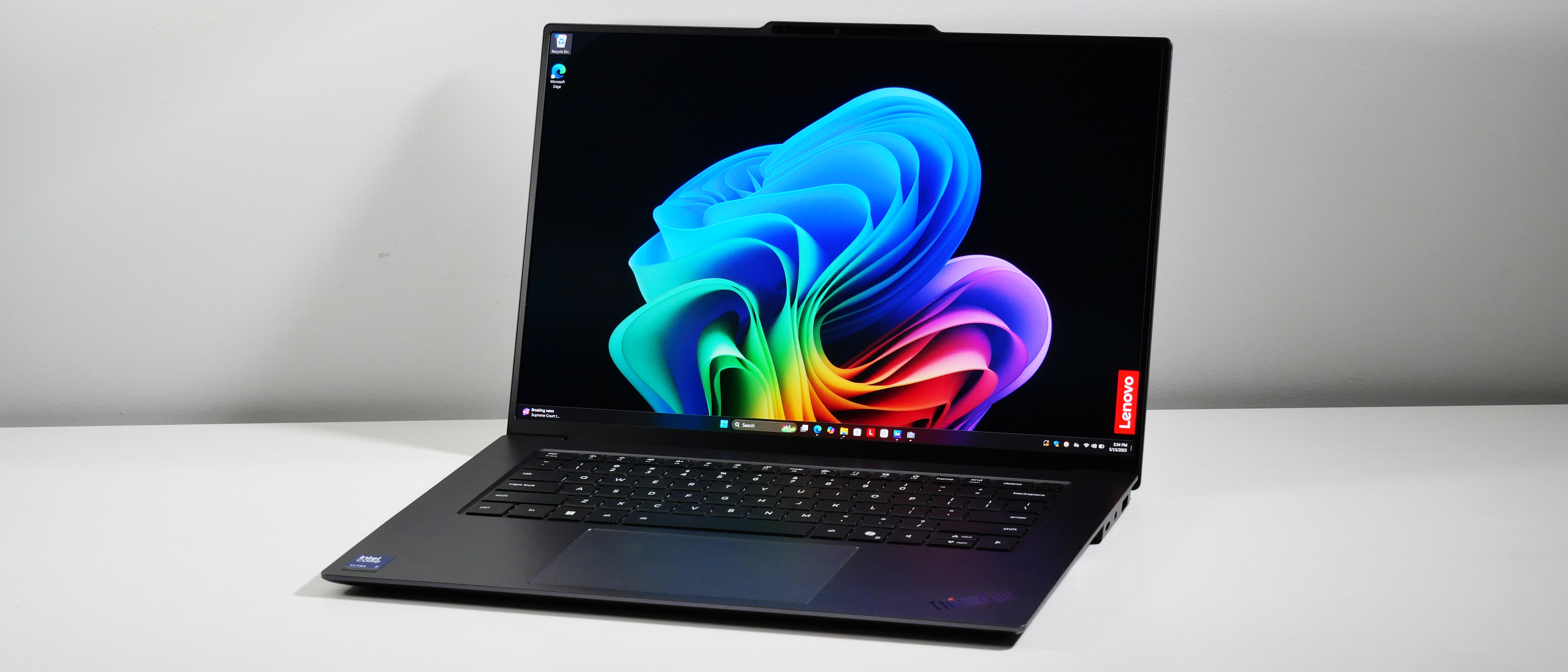 Lenovo ThinkPad X9-15 Gen 1 Aura Edition open at an angle on a white desk.