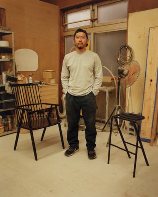 Kodai Iwamoto at his maker space in Tokyo, with his 'Possum' chair and 'Bent' stool