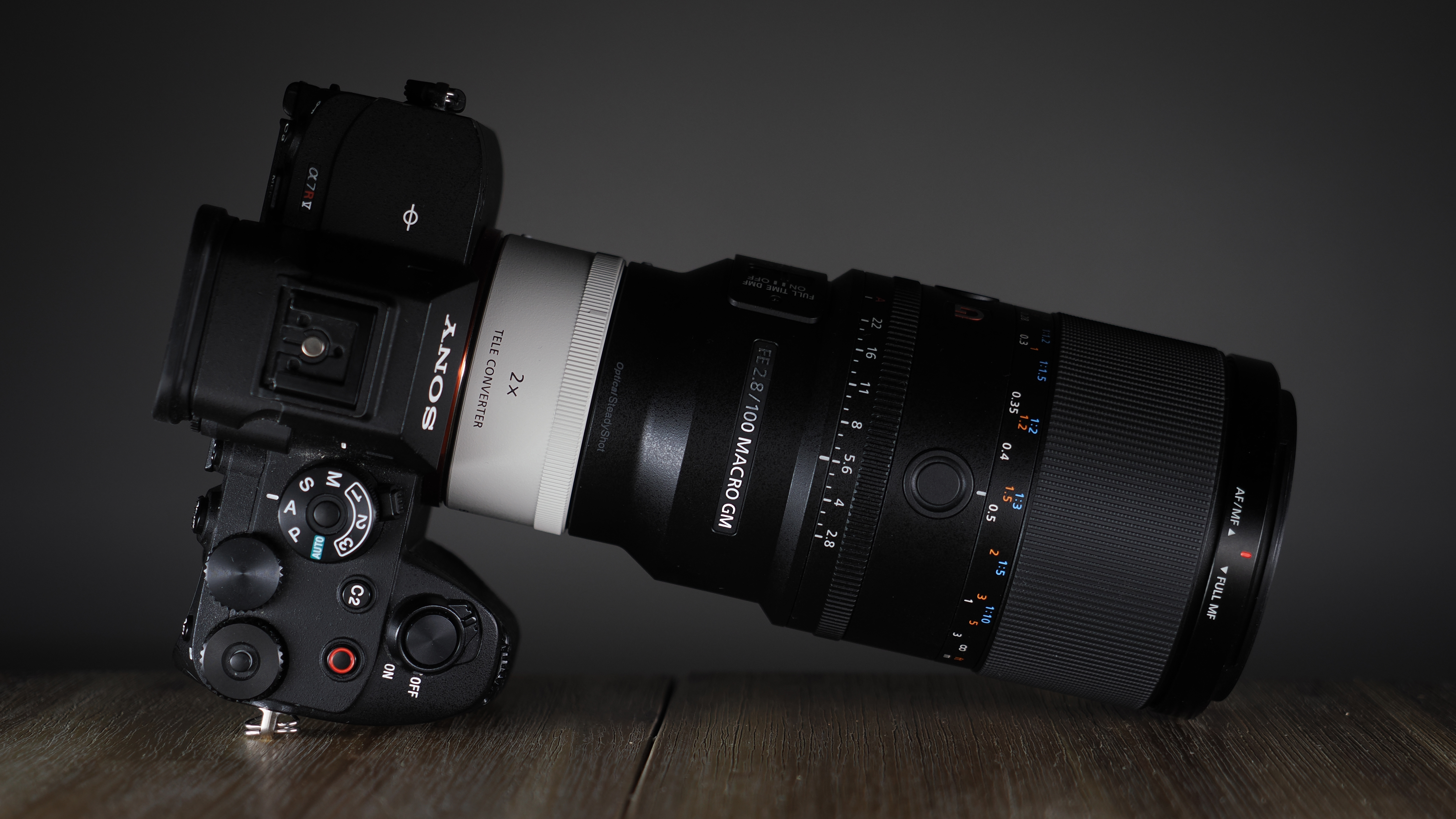 Sony FE 100mm f/2.8 Macro GM OSS on a wooden surface