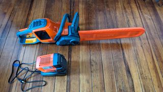 The chainsaw with blade cover and charger