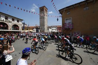 Spectators cheer as the pack of riders parades at the start of the 19th stage of the Giro dItalia 2022 cycling race 178 kilometers from Marano Lagunare to Santuario di Castelmonte northeastern Italy on May 27 2022 Photo by Luca Bettini AFP Photo by LUCA BETTINIAFP via Getty Images