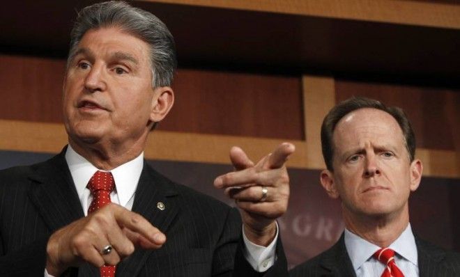 Sens. Joe Manchin and Pat Toomey, co-sponsors of a measure to expand background checks.