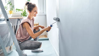 woman painting wall