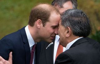 Britain's Prince William (L) receives a "hongi", a traditional Maori greeting, by a Maori elder during a welcoming at Government House in Wellington on April 7, 2014. Britain's Prince William