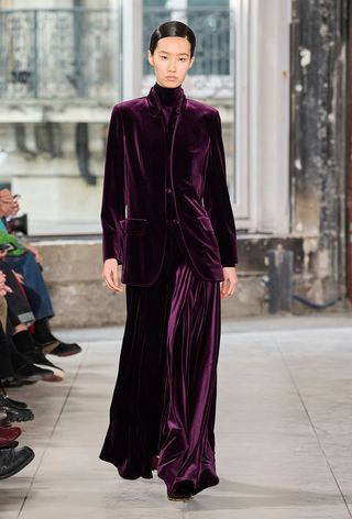 how to wear velvet is shown in a photo from Akris's fall 2024 runway show with a model wearing an eggplant velvet blazer over a matching turtleneck and maxi skirt