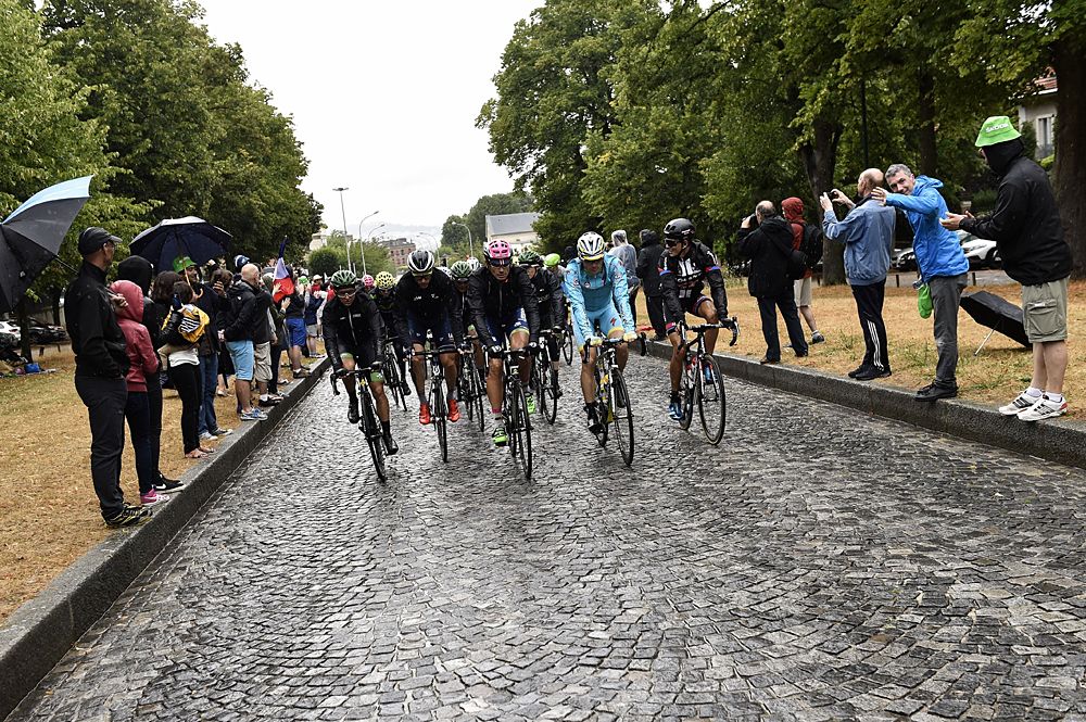 Team Sky and the peloton ride onto the Champs-Elysees