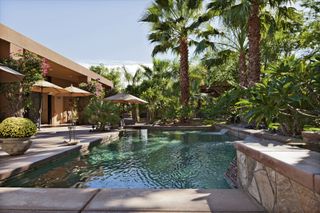 Pool landscaping ideas with backyard pool and tropical planting