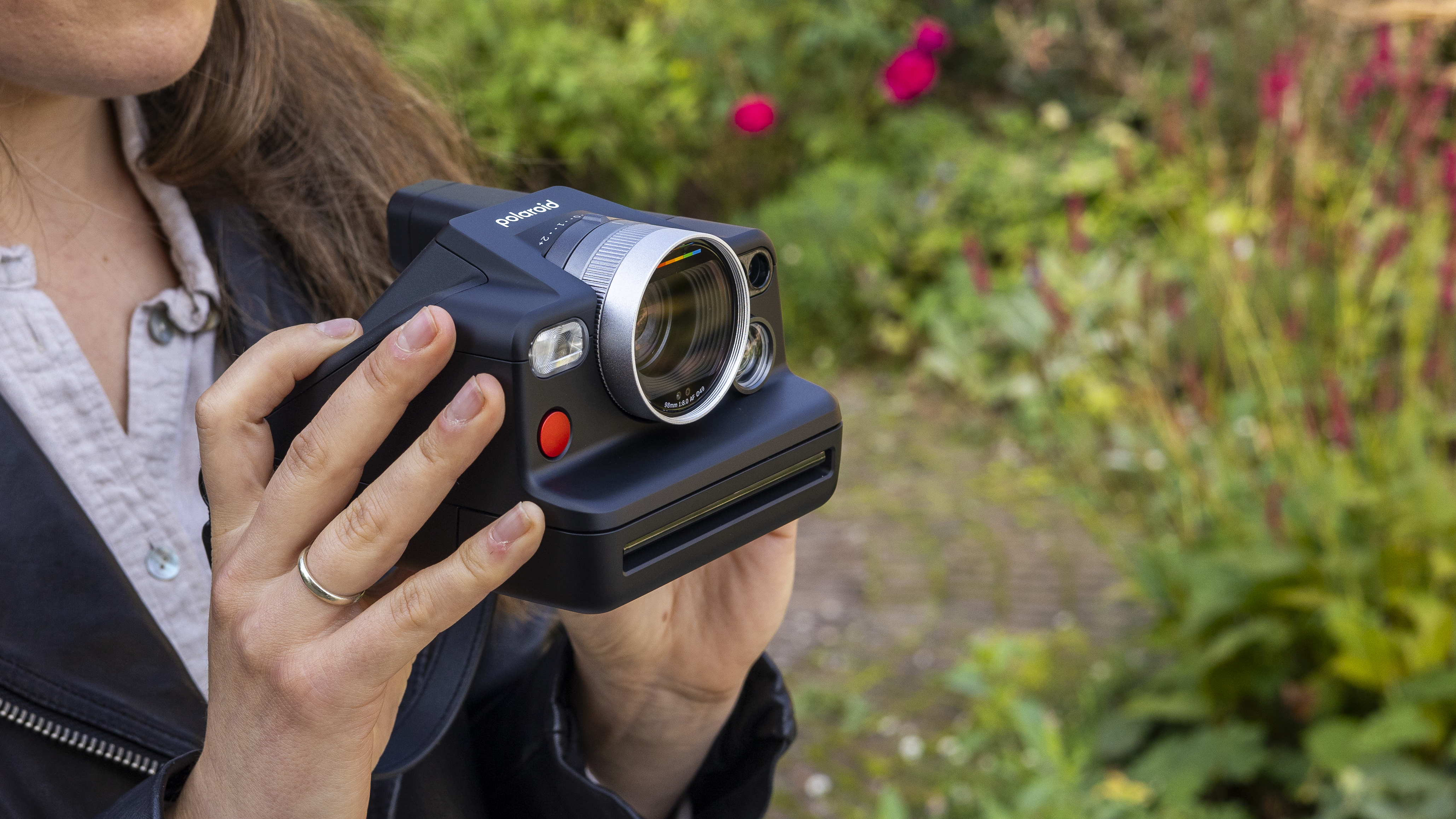 A female photographer holding the Polaroid I-2 instant camera in her hands