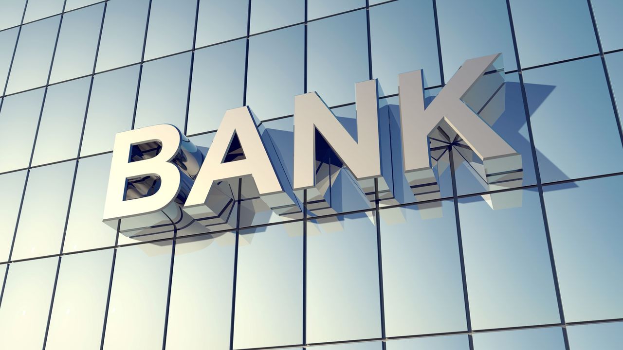 A windowed wall with the word &quot;bank&quot; on it. 