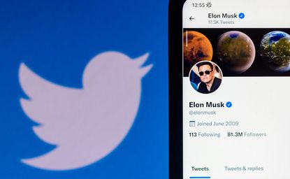 Twitter logo and smartphone displaying Elon Musk's Twitter profile