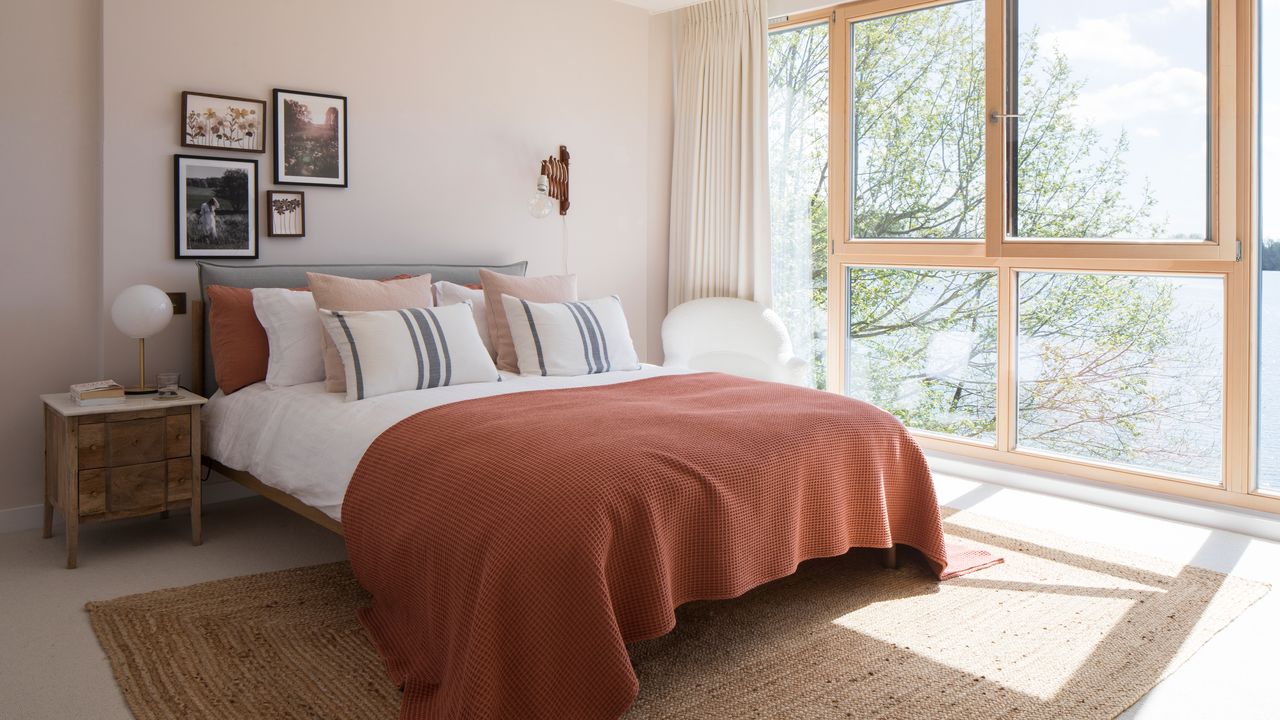 Pink bedroom with art work above the bed