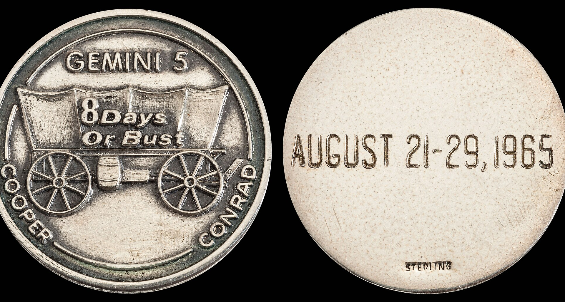 Two silver coins sit side by side against a dark background, with the left with a wagon and the phrase "8 days or bust" and two names, Cooper and Conrad on it. The right coin has the dates August 21-29, 1965.