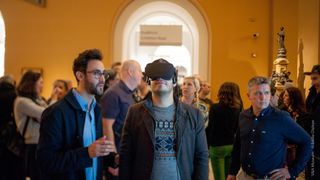 Visitors try out Pigment Channel in VR, with artist Patrick Morgan (far right).