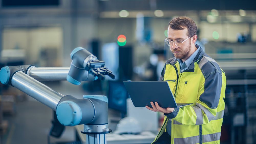 A man operating a robotic arm