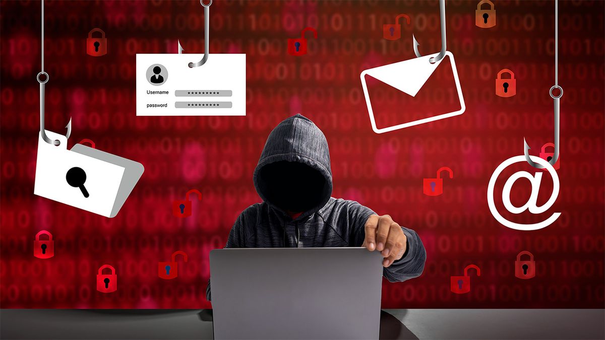 Hooded cybercriminal sitting with laptop surround by hooks with internet-based logos hanging from them