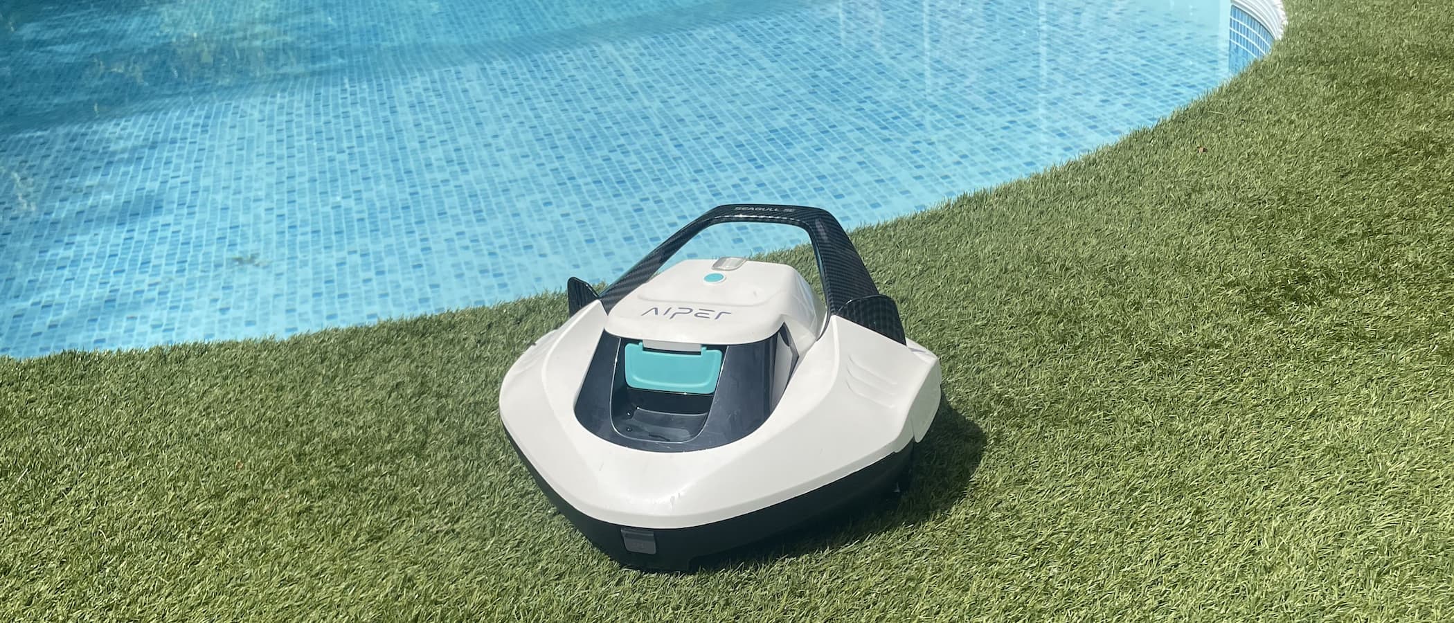 An Aiper robot vacuum on astroturf