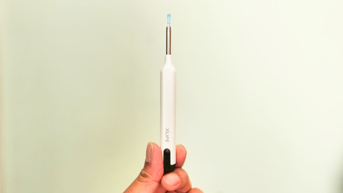 Xlife wireless endoscope camera being used to remove ear wax in ear.