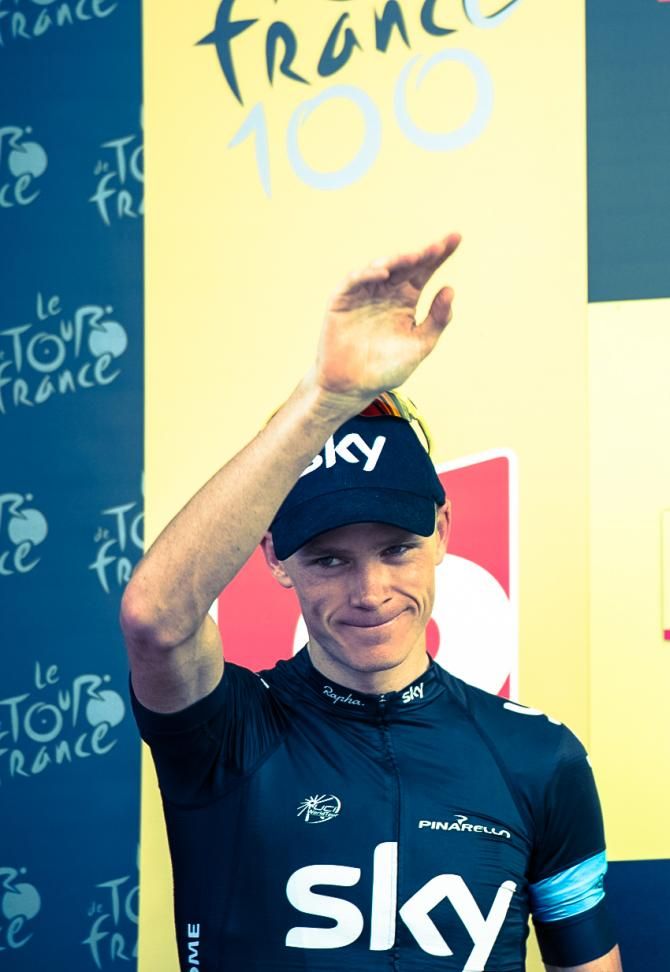 Tour de France leader Chris Froome (Sky) steps onto the podium to receive the yellow jersey